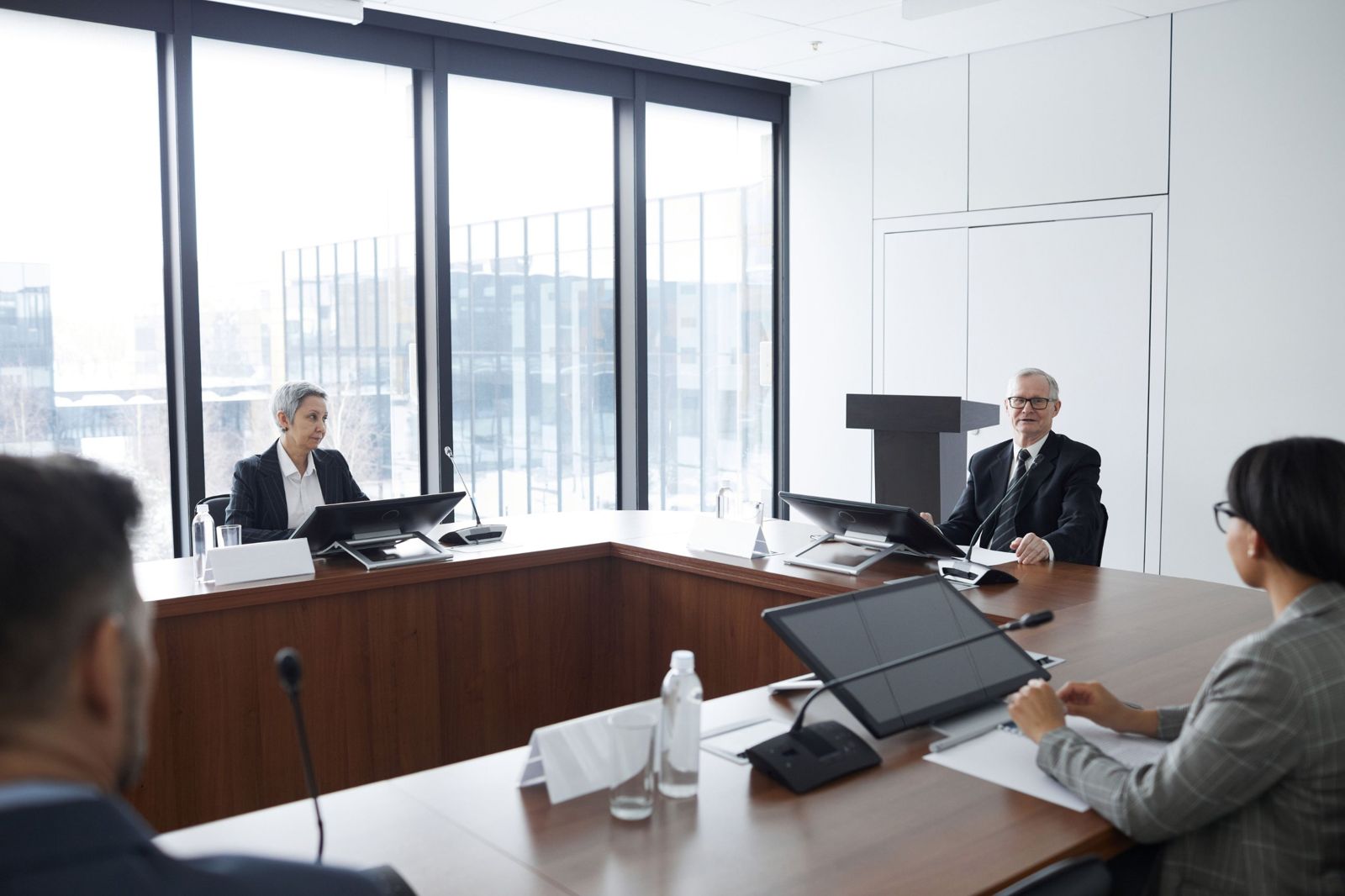 A business meeting in a glass-walled boardroom